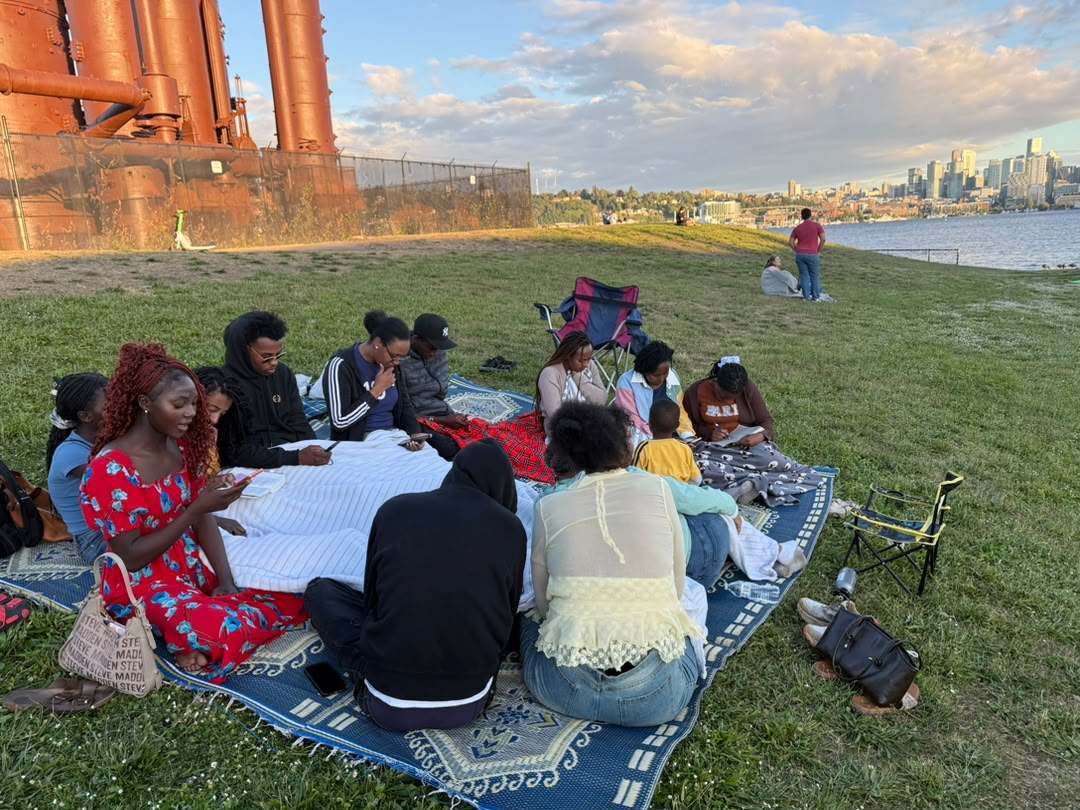 Reading together on the grass by the water